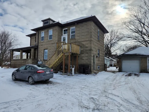 a car parked in front of white house