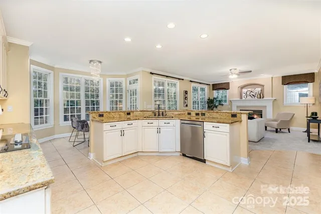 a large white kitchen with a large window
