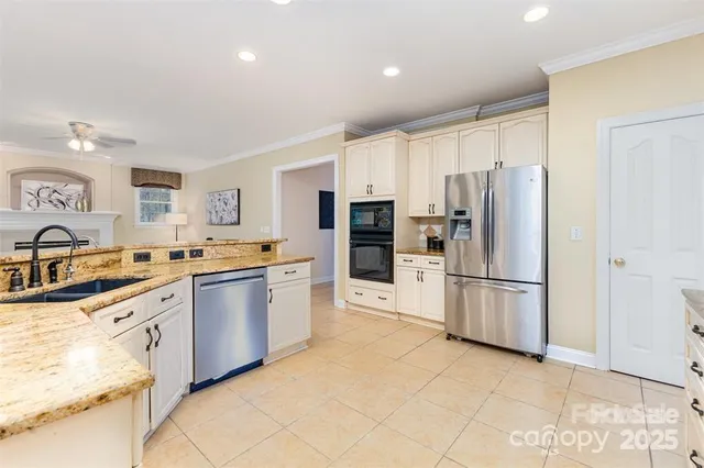 a kitchen with stainless steel appliances a refrigerator sink and microwave