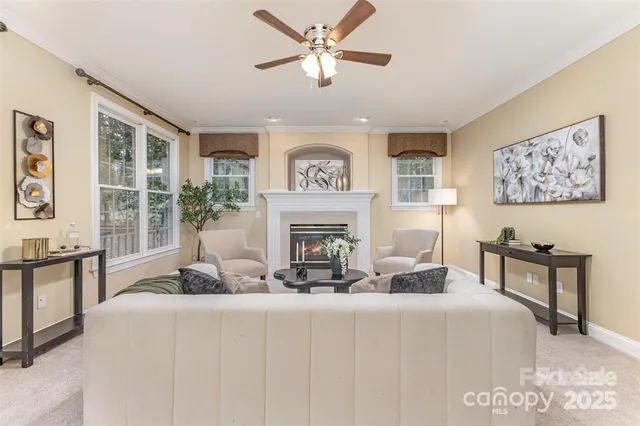 a living room with furniture a fireplace and windows