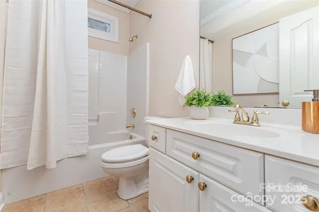 a bathroom with a granite countertop sink a toilet and a mirror