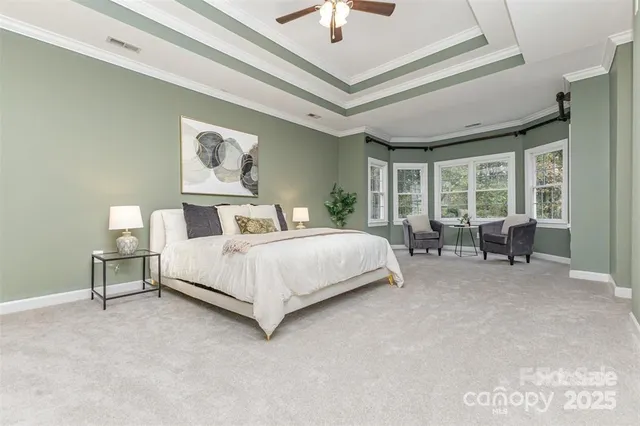 a bedroom with a bed a table and painting