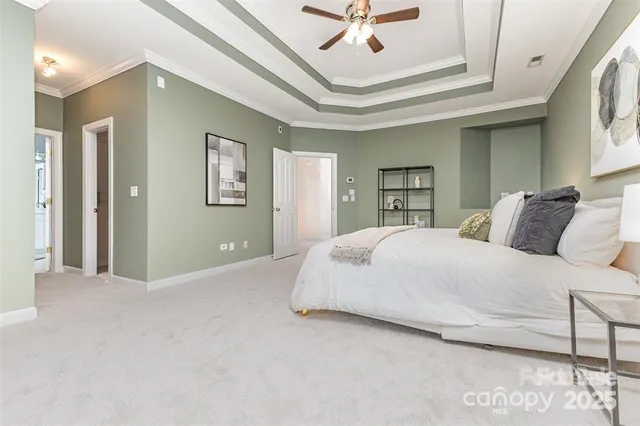 a spacious bedroom with a bed and a chandelier