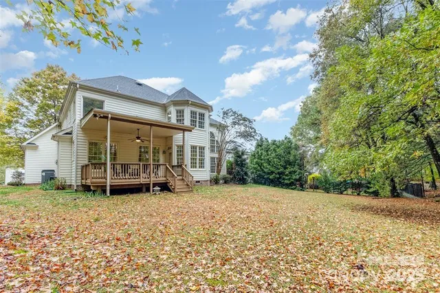 a view of a house with a yard and sitting area
