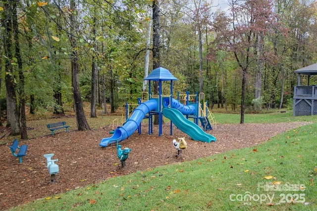 a view of outdoor space with playground and green space