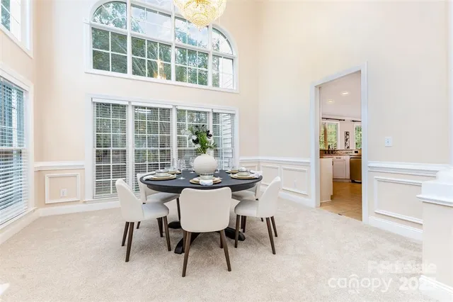 a view of a dining room with a table and chairs