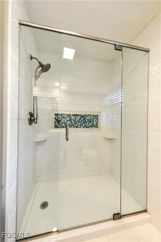 a bathroom with a glass shower door