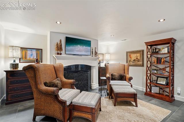 2204 Rocking Horse Court Colorado Springs, CO 80921 - Photo 23 of 50 Living area with a premium fireplace and dark tile patterned floors