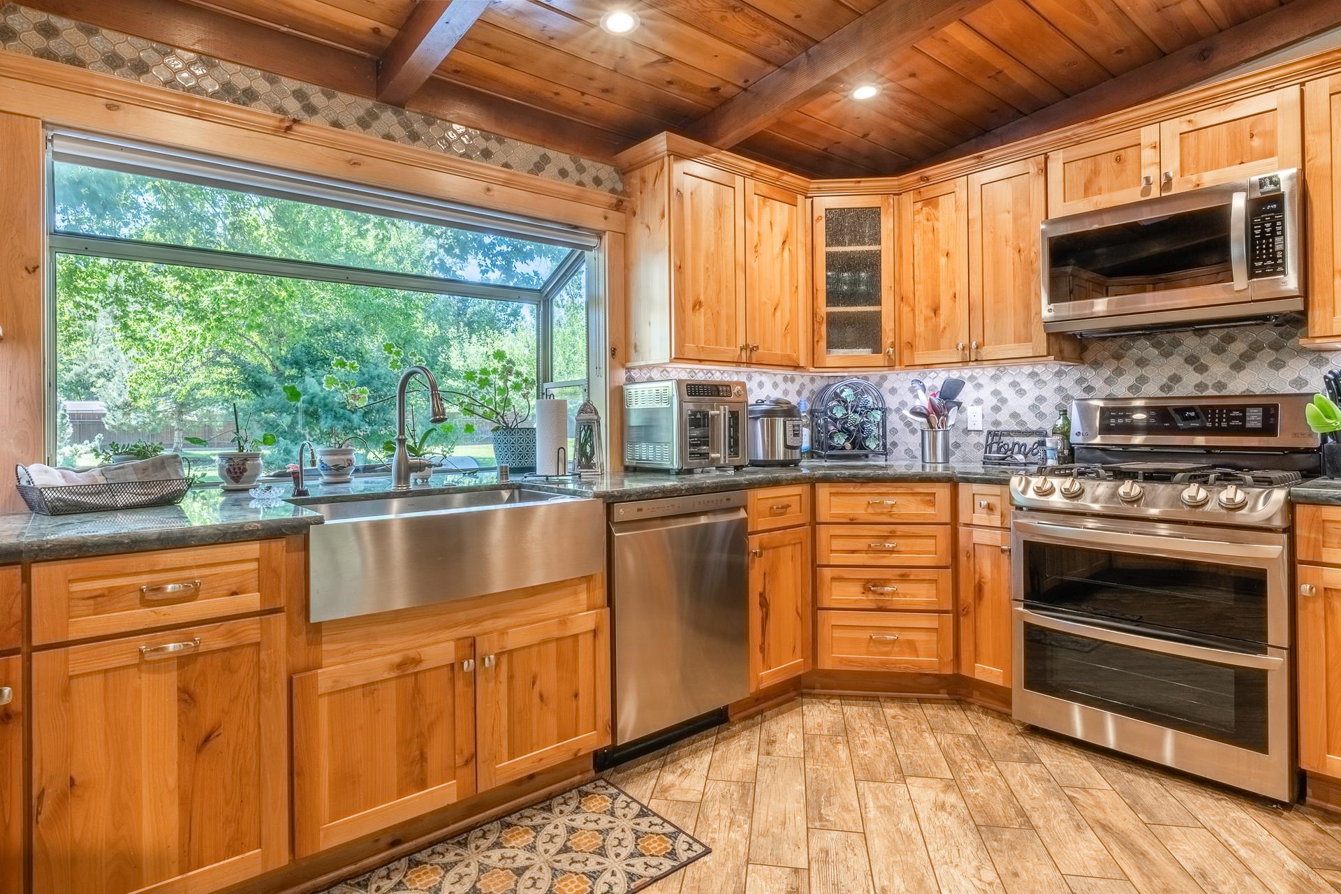 325 Mt Tom Road Bishop, CA 93514 - Photo 13 of 33 a kitchen with stainless steel appliances granite countertop a stove a sink and a microwave