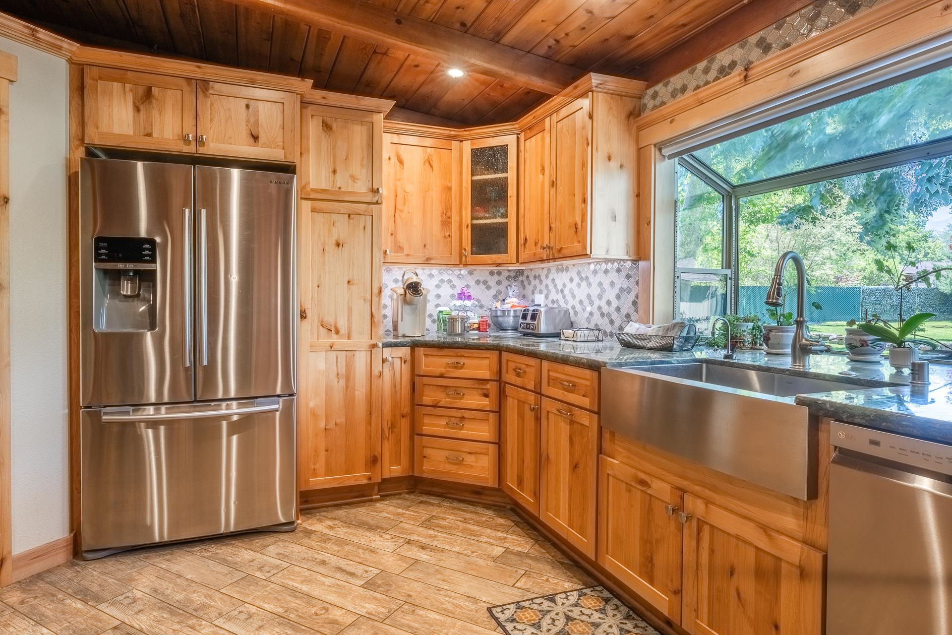 325 Mt Tom Road Bishop, CA 93514 - Photo 14 of 33 a kitchen with stainless steel appliances granite countertop a refrigerator a sink and dishwasher