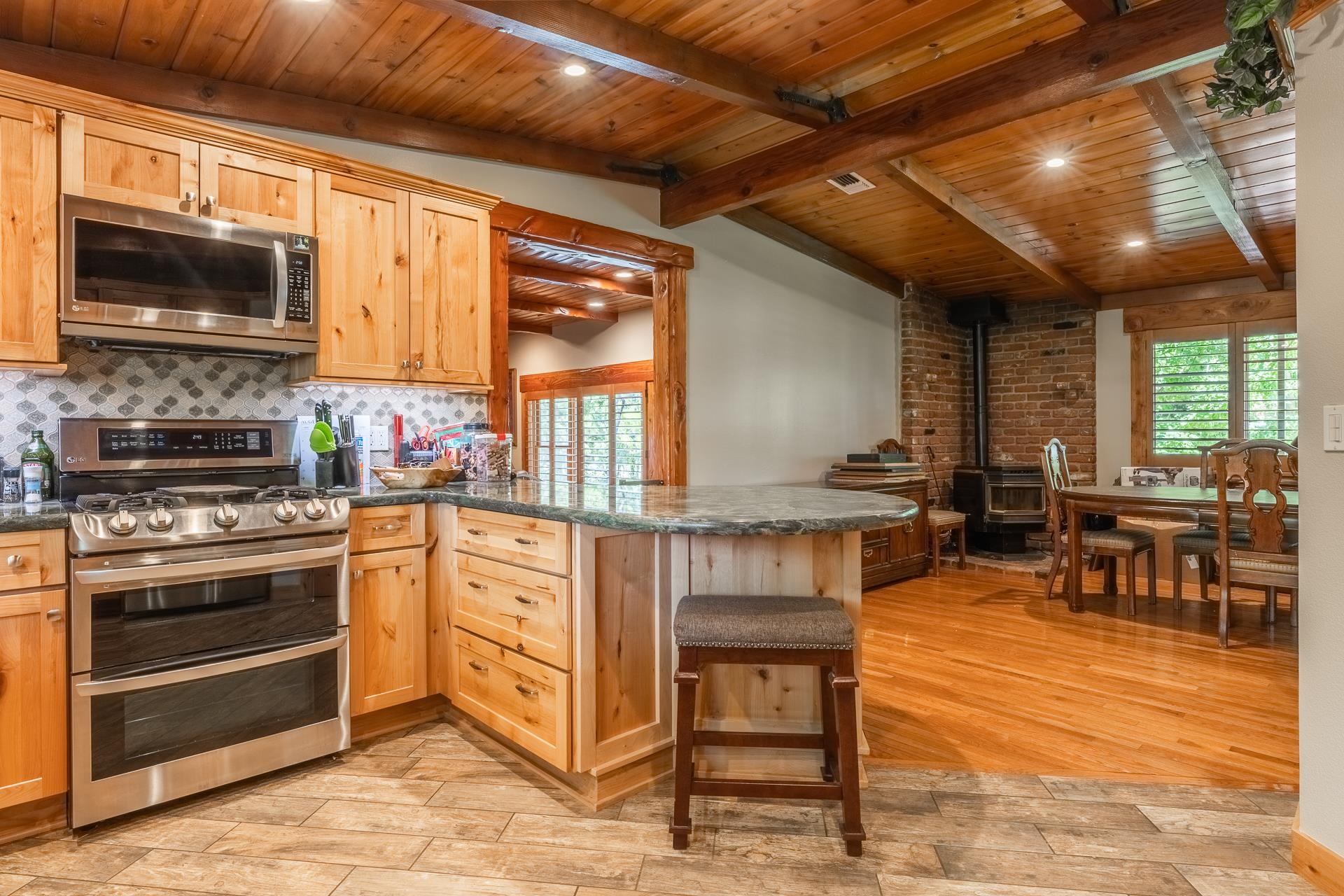 325 Mt Tom Road Bishop, CA 93514 - Photo 16 of 33 a kitchen with stainless steel appliances granite countertop a stove and a wooden cabinets