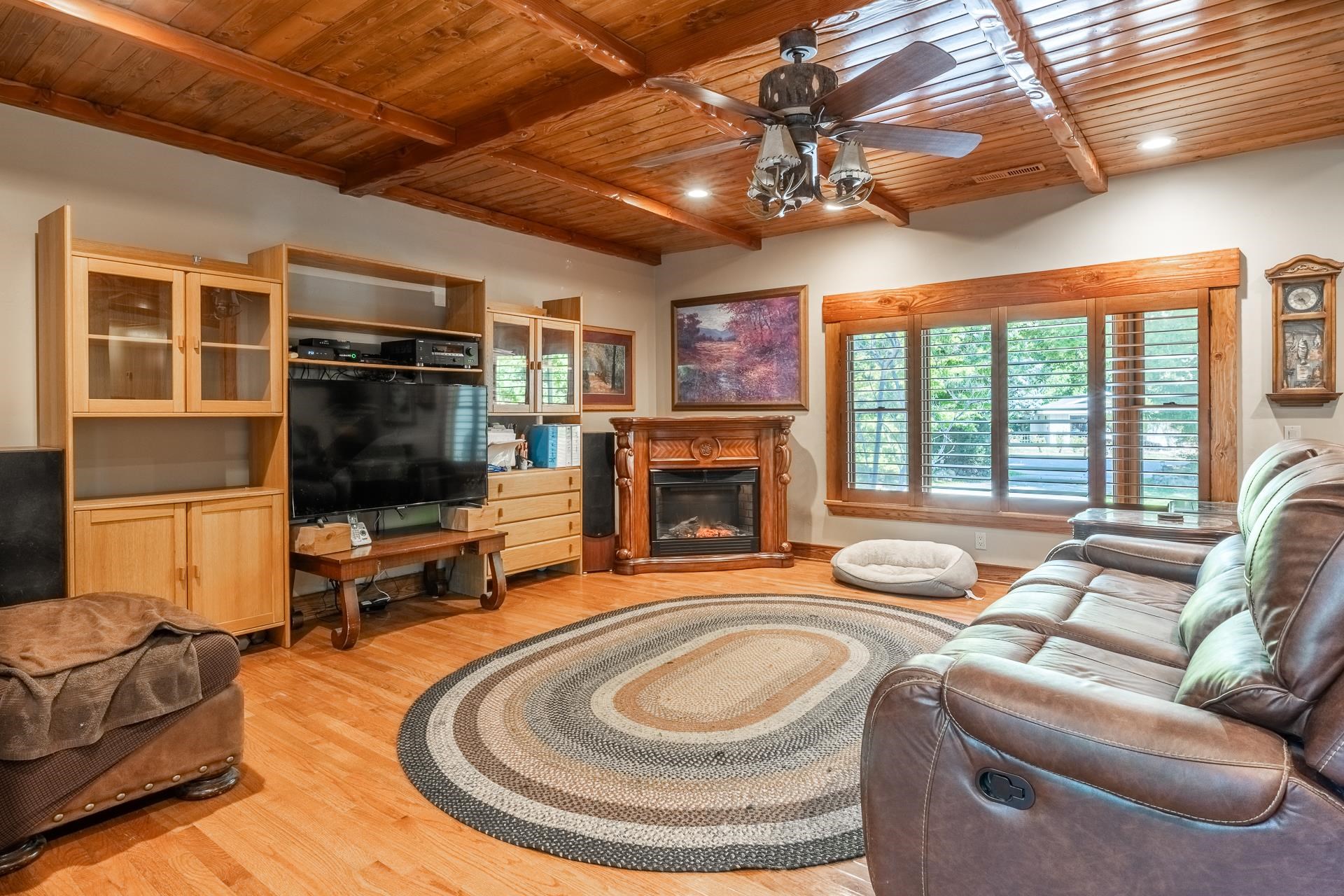 325 Mt Tom Road Bishop, CA 93514 - Photo 8 of 33 a living room with furniture a flat screen tv and a fireplace