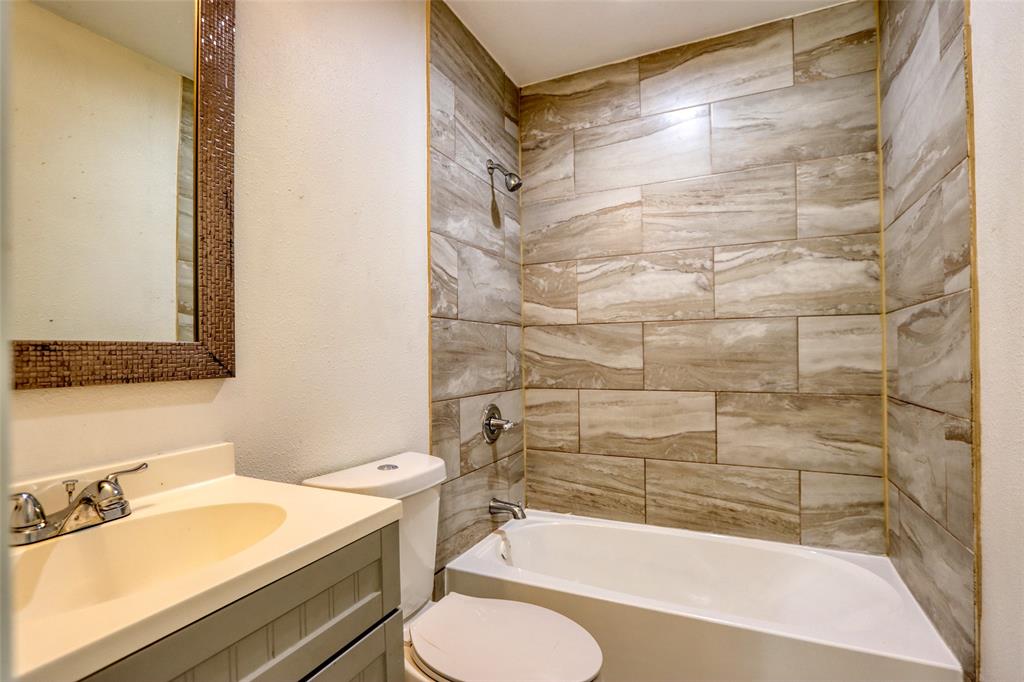 4520 Utah Avenue Dallas, TX 75216 - Photo 13 of 27 a bathroom with a sink mirror bathtub and toilet