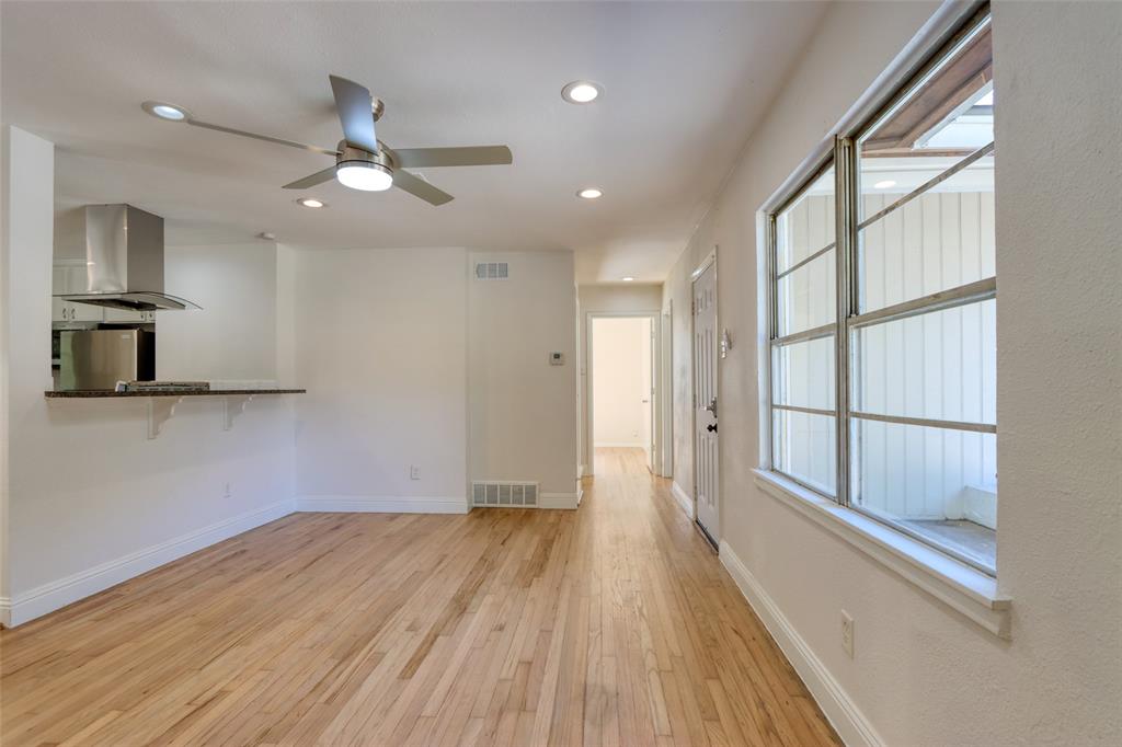 4520 Utah Avenue Dallas, TX 75216 - Photo 4 of 27 a view of empty room with wooden floor and fan