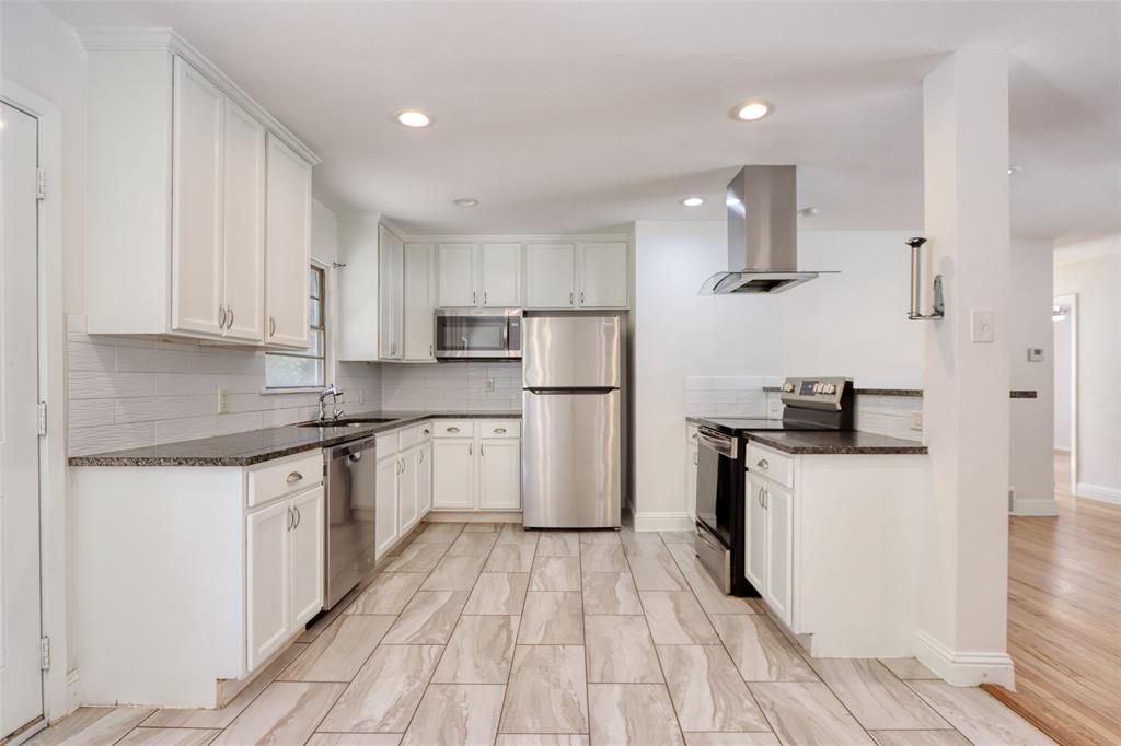4520 Utah Avenue Dallas, TX 75216 - Photo 7 of 27 a kitchen with granite countertop a sink and steel appliances
