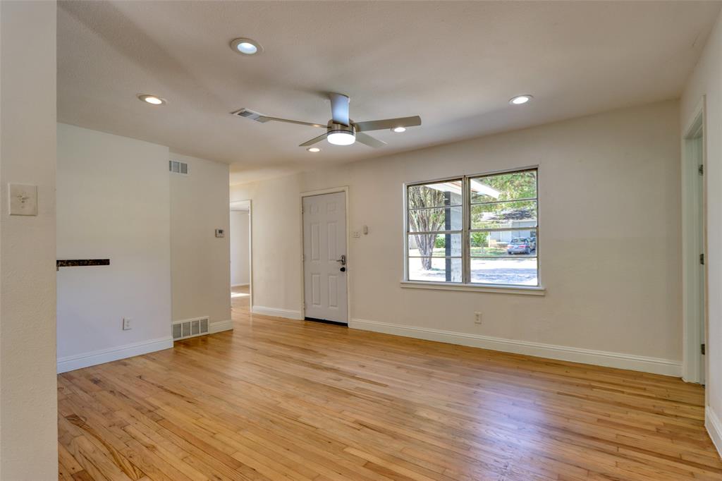 4520 Utah Avenue Dallas, TX 75216 - Photo 8 of 27 a view of an empty room with wooden floor and a window