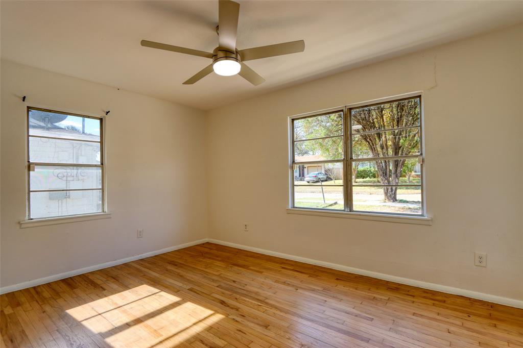4520 Utah Avenue Dallas, TX 75216 - Photo 9 of 27 a view of an empty room with wooden floor and a window