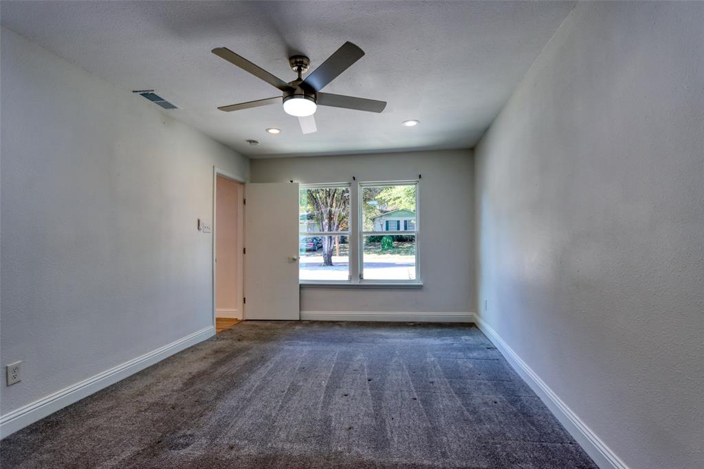 4520 Utah Avenue Dallas, TX 75216 - Photo 10 of 27 an empty room with wooden floor fan and windows
