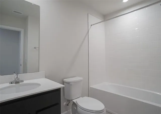 a bathroom with a toilet and a bathtub