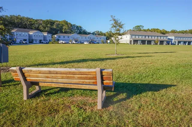 a sign that is sitting in the middle of a park