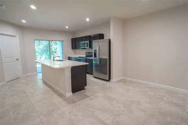 a kitchen with refrigerator and cabinets