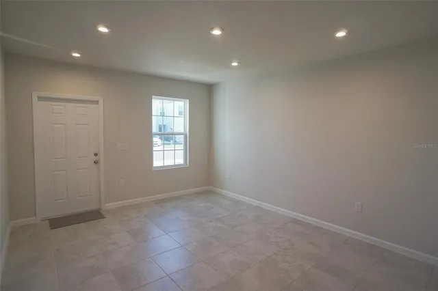 a view of an empty room with a window
