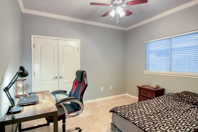 a bedroom with furniture and a window