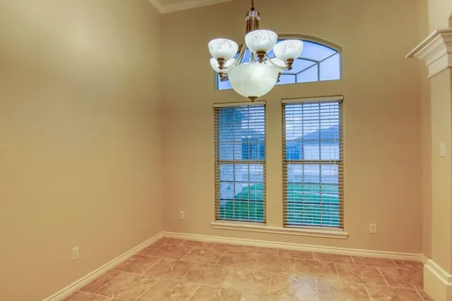 a view of a room with a large window and chandelier
