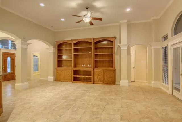 en view of a livingroom with a furniture and a ceiling fan