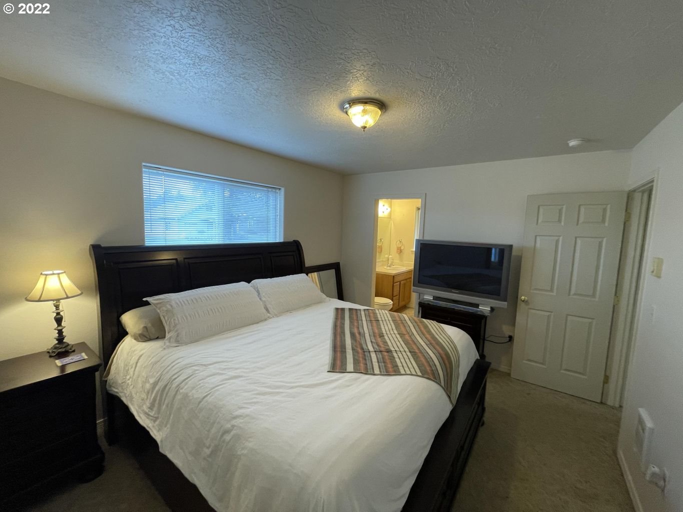 3413 Maple Lane Tillamook, OR 97141 - Photo 11 of 32 a bedroom with bed and a tv