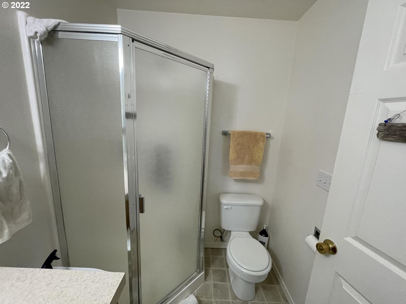 3413 Maple Lane Tillamook, OR 97141 - Photo 16 of 32 a bathroom with a shower and a toilet