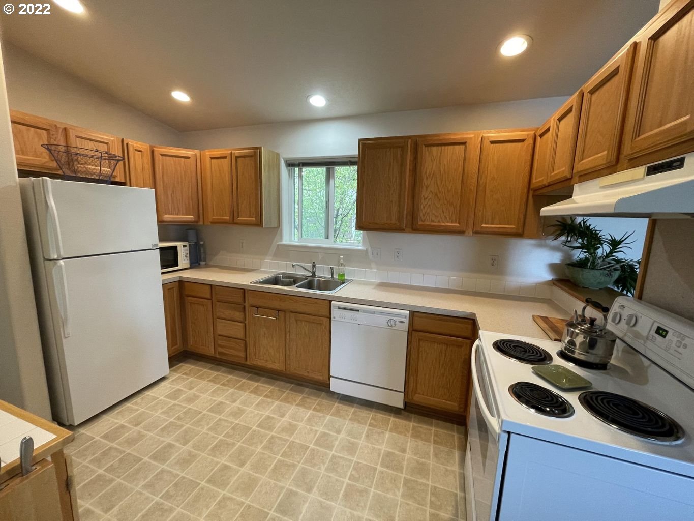 3413 Maple Lane Tillamook, OR 97141 - Photo 2 of 32 a kitchen with a refrigerator sink and cabinets