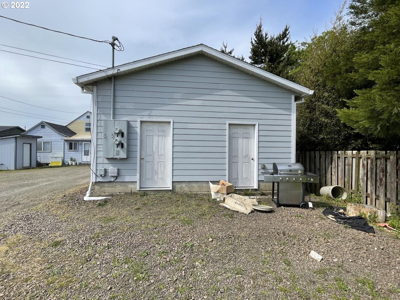 3413 Maple Lane Tillamook, OR 97141 - Photo 27 of 32 a backyard of a house with table and chairs