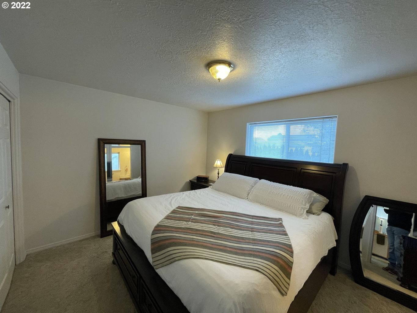 3413 Maple Lane Tillamook, OR 97141 - Photo 10 of 32 a bedroom with a bed and a night stand