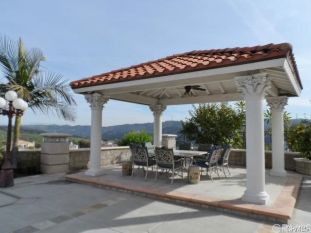 3068 Windmill Drive Diamond Bar, CA 91765 - Photo 32 of 35 a view of a patio with table and chairs potted plants and palm tree