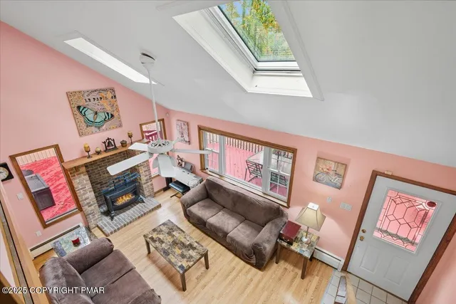 a view of a workspace with wooden floor and a window