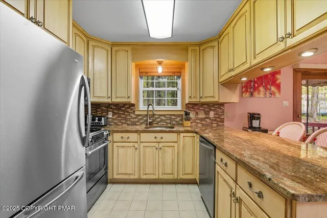 a bedroom with a bed chandelier and a window