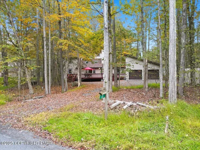 a view of a house with a yard and deck