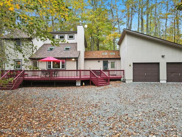 a roof deck with a table and chairs under an umbrella
