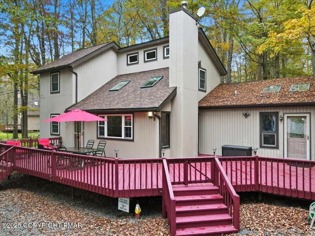 a living room with furniture large window and fireplace