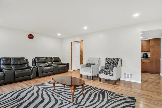 a living room with furniture and wooden floor