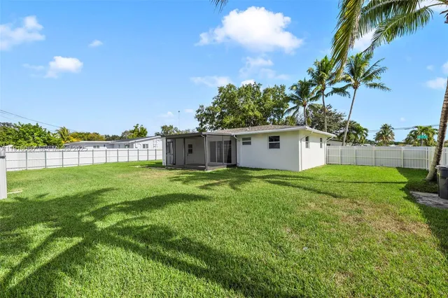 a front view of house with a garden
