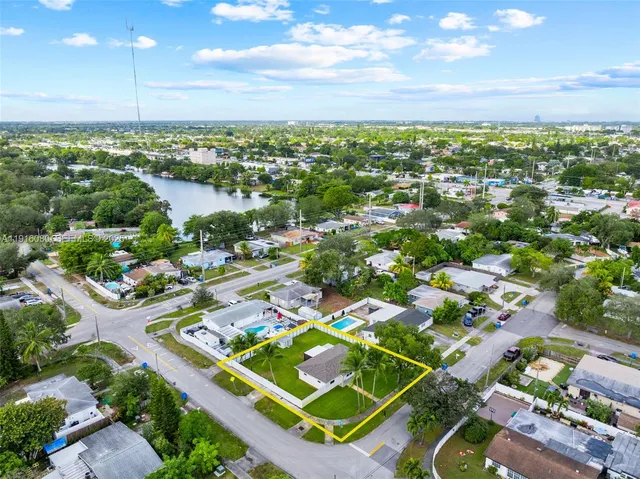 an aerial view of a house with a big yard