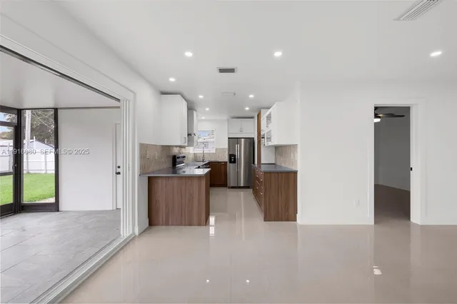 a view of a kitchen with refrigerator and microwave