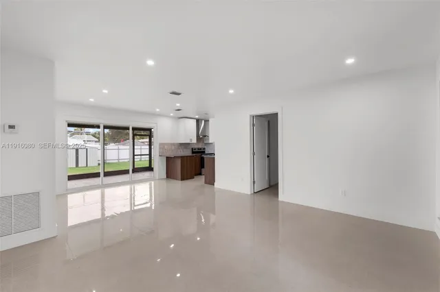 a view of a kitchen with a sink and refrigerator