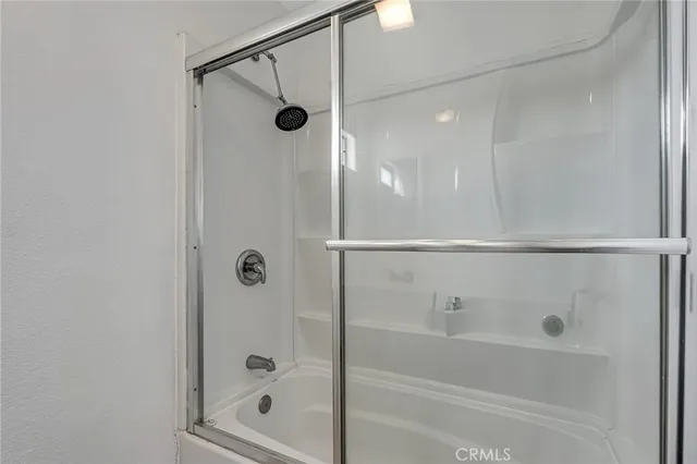 a bathroom with a glass shower door