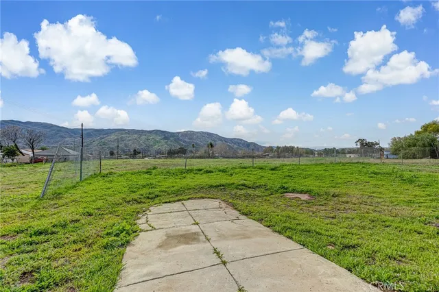 a view of a big yard with lots of green space