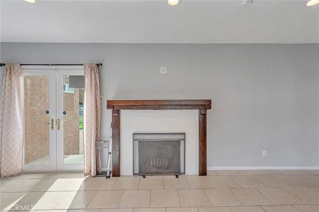 a view of a livingroom with an empty space and a fireplace
