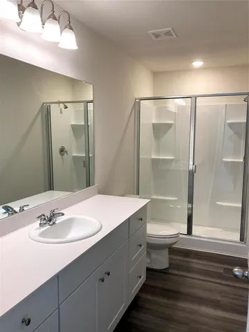 a bathroom with a sink toilet and shower