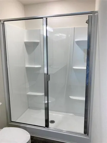 a bathroom with a glass shower door